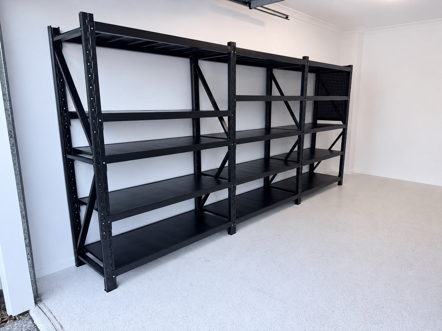 Double-garage storage wall — two shelving bays