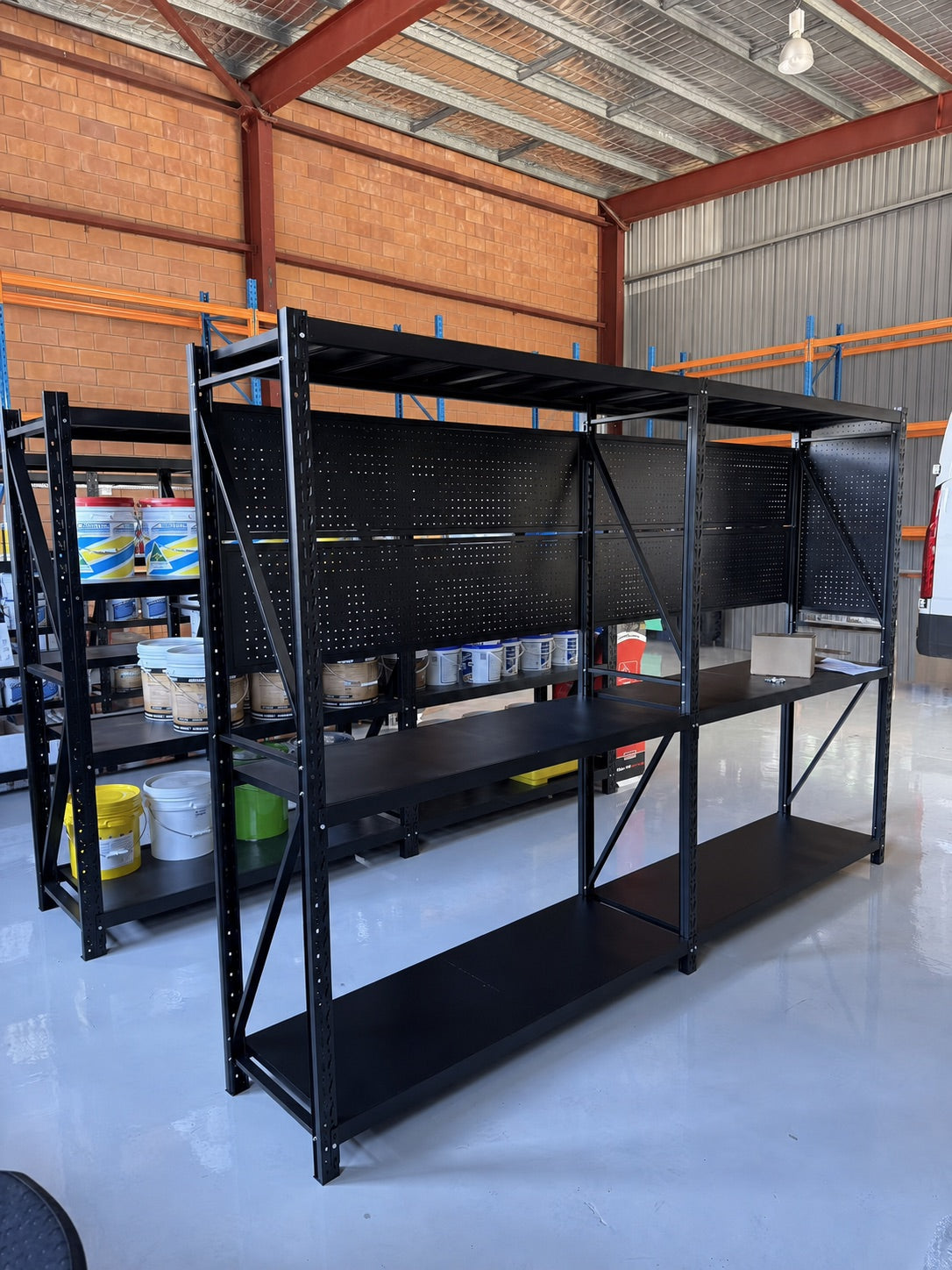 Workshop bench with pegboard, tools and drawer cabinets